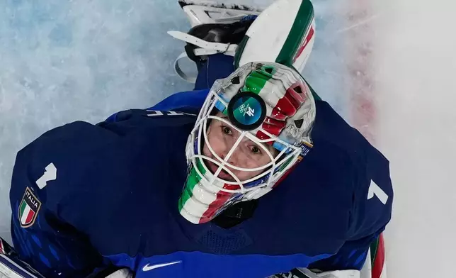 Italy's goalkeeper Gabriella Durante fails to save the puck as Japan's Akane Shiga scores her side's second goal during a preliminary round match of women's ice hockey between Japan and Italy at the 2026 Winter Olympics, in Milan, Italy, Monday, Feb. 9, 2026. (AP Photo/Hassan Ammar)
