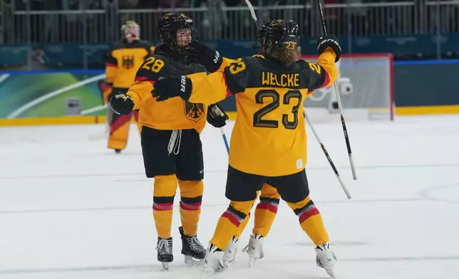 Germany's Katarina Jobst-Smith (28) celebrates scoring the winning goal with Germany's Lilli Welcke (23) in overtime against France during a preliminary round match of women's ice hockey at the 2026 Winter Olympics, in Milan, Italy, Monday, Feb. 9, 2026. (AP Photo/Carolyn Kaster)