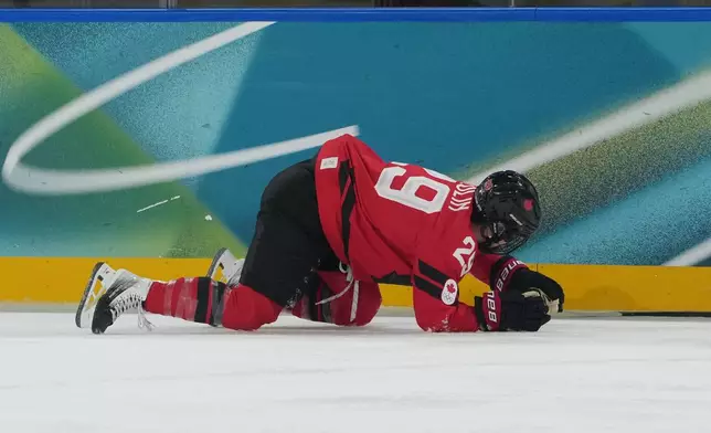 Canada's Marie-Philip Poulin (29) is down on the ice in the first period against Czechia during a preliminary round match of women's ice hockey at the 2026 Winter Olympics, in Milan, Italy, Monday, Feb. 9, 2026. (AP Photo/Carolyn Kaster)