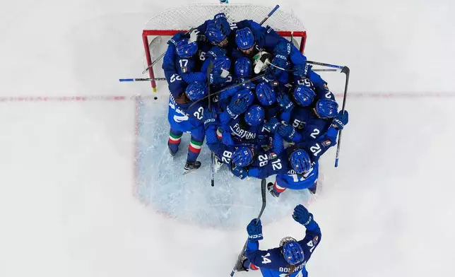 Italy players celebrate end of a preliminary round match of women's ice hockey between Japan and Italy at the 2026 Winter Olympics, in Milan, Italy, Monday, Feb. 9, 2026. (AP Photo/Hassan Ammar)