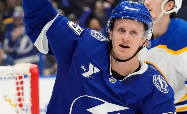 Tampa Bay Lightning center Jake Guentzel (59) celebrates after scoring against the Buffalo Sabres during overtime in an NHL hockey game Tuesday, Feb. 3, 2026, in Tampa, Fla. (AP Photo/Chris O'Meara)