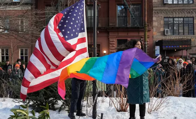 New York politicians and activists prepare to raise a rainbow flag on a pole in Christopher Park across the street from the Stonewall Inn, Thursday, Feb. 12, 2026, in New York, a few days after it was removed by the National Park Service to comply with guidance from the Trump administration. (AP Photo/Yuki Iwamura)