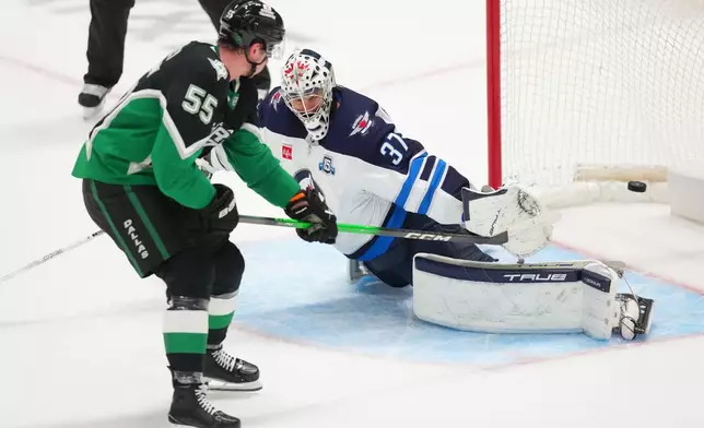 Dallas Stars defenseman Thomas Harley (55) scores the game-winning goal on Winnipeg Jets goaltender Connor Hellebuyck during overtime in an NHL hockey game Monday, Feb. 2, 2026, in Dallas. (AP Photo/Julio Cortez)