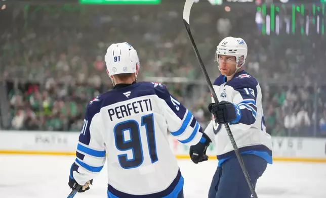 Winnipeg Jets center Gabriel Vilardi, right, celebrates his first period goal with center Cole Perfetti (91) during an NHL hockey game against the Dallas Stars Monday, Feb. 2, 2026, in Dallas. (AP Photo/Julio Cortez)
