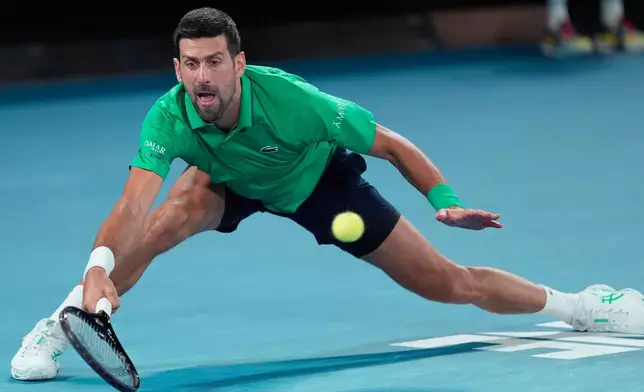 Novak Djokovic of Serbia hits a forehand to Carlos Alcaraz of Spain during the men's singles final at the Australian Open tennis championship in Melbourne, Australia, Sunday, Feb. 1, 2026. (AP Photo/Asanka Brendon Ratnayake)
