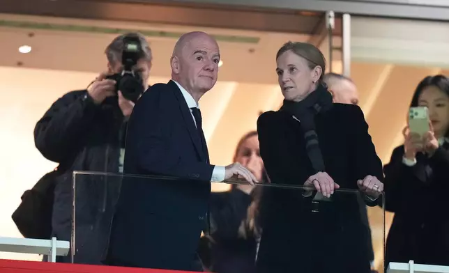 FIFA President Gianni Infantino and Chief Football Officer Jill Ellis chat on the tribune before the start of the Women's Champions Cup final soccer match between Arsenal FC and SC Corinthians in London, Sunday, Feb. 1, 2026. (AP Photo/Alastair Grant)