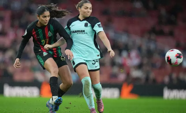 Gotham's Khyah Harper, right, challenges Asfar's Hajar Said for the ball during the Women's Champions Cup third-fourth place play off soccer match between Gotham FC and Asfar in London, Sunday, Feb. 1, 2026. (AP Photo/Alastair Grant)