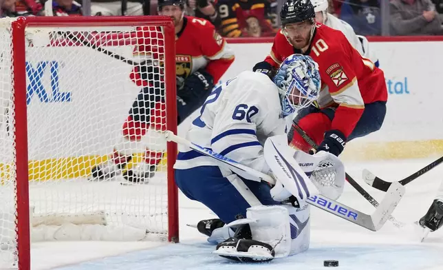 Toronto Maple Leafs goaltender Joseph Woll (60) defends a shot by Florida Panthers left wing A.J. Greer (10) during the second period of an NHL hockey game, Thursday, Feb. 26, 2026, in Sunrise, Fla. (AP Photo/Lynne Sladky)