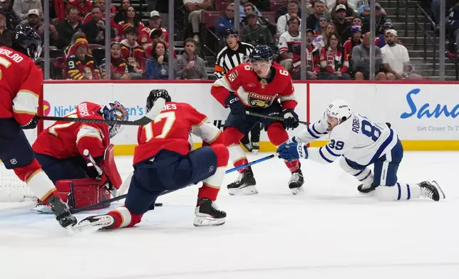 Florida Panthers goaltender Sergei Bobrovsky, left, defends a shot on the goal by Toronto Maple Leafs left wing Nicholas Robertson (89) during the first period of an NHL hockey game, Thursday, Feb. 26, 2026, in Sunrise, Fla. (AP Photo/Lynne Sladky)