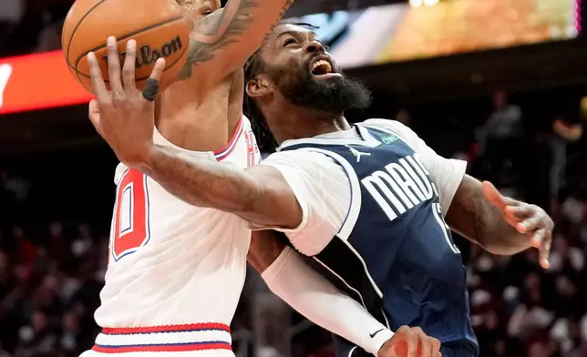 Dallas Mavericks forward Naji Marshall, right, shoots as Houston Rockets forward Jabari Smith Jr., left, defends during the first half of an NBA basketball game Saturday, Jan. 31, 2026, in Houston. (AP Photo/Eric Christian Smith)