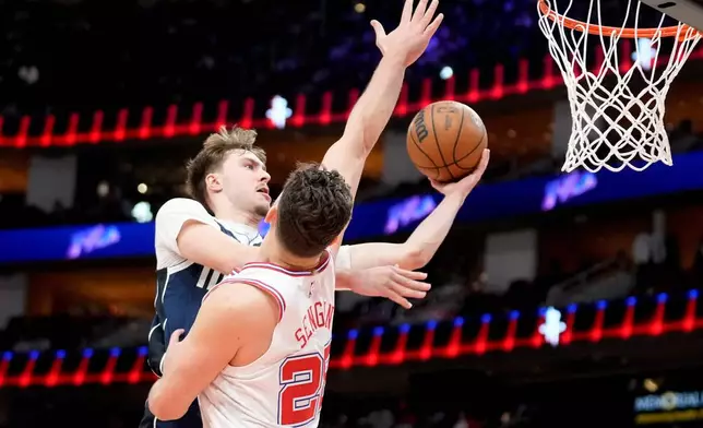Dallas Mavericks forward Cooper Flagg, left, drives to the basket as Houston Rockets center Alperen Sengun, right, defends during the first half of an NBA basketball game Saturday, Jan. 31, 2026, in Houston. (AP Photo/Eric Christian Smith)
