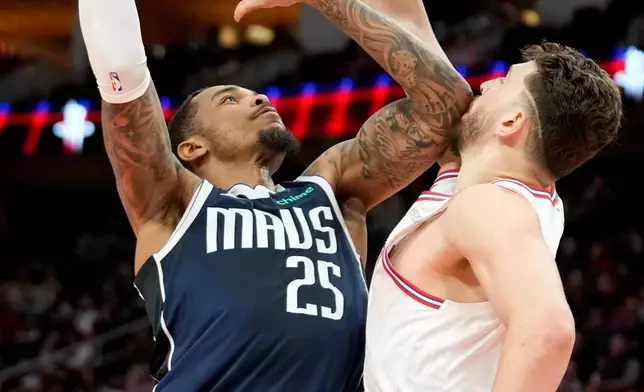 Dallas Mavericks forward P.J. Washington (25) looks to shoot as Houston Rockets center Alperen Sengun, right, defends during the first half of an NBA basketball game Saturday, Jan. 31, 2026, in Houston. (AP Photo/Eric Christian Smith)
