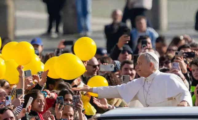 Pope Leo XIV arrives in St. Peter's Square at the Vatican for his open-air weekly general audience, Wednesday, Feb. 18, 2026. (AP Photo/Gregorio Borgia)
