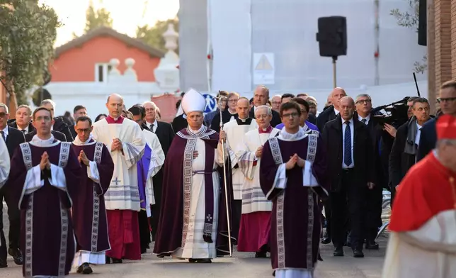 Pope Leo XIV, center, arrives, with bishops and cardinals in a penitential procession marking the start of the Catholic Lent, at the Basilica of Santa Sabina in Rome, Wednesday, Feb. 18, 2026, where he will preside over Ash Wednesday Mass. (AP Photo/Riccardo De Luca)