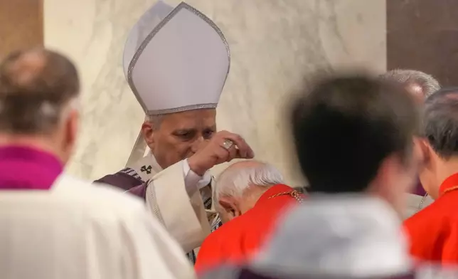 Pope Leo XIV administers the ashes during Ash Wednesday Mass, marking the start of Catholic Lent, inside the Basilica of Santa Sabina in Rome, Wednesday, Feb. 18, 2026. (AP Photo/Gregorio Borgia)