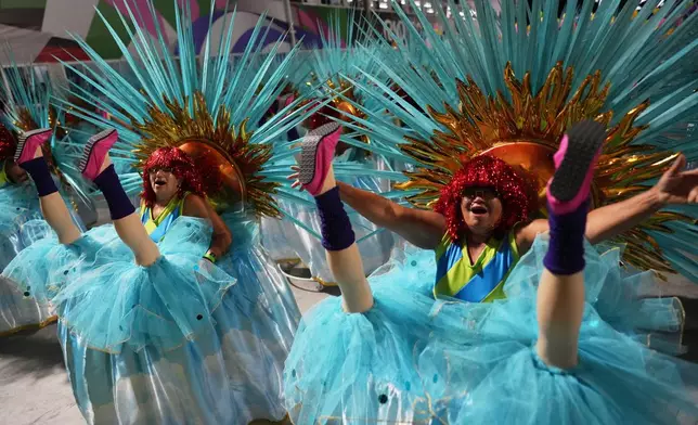 Performers from the Mocidade samba school parade during Carnival celebrations at the Sambadrome in Rio de Janeiro, late Monday, Feb. 16, 2026. (AP Photo/Silvia Izquierdo)