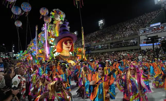 Performers from the Mocidade samba school parade during Carnival celebrations at the Sambadrome in Rio de Janeiro, Monday, Feb. 16, 2026. (AP Photo/Silvia Izquierdo)