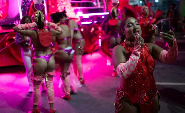 A performer does her makeup ahead of the Carnival parade at the Sambadrome in Rio de Janeiro, Monday, Feb. 16, 2026. (AP Photo/Bruna Prado)