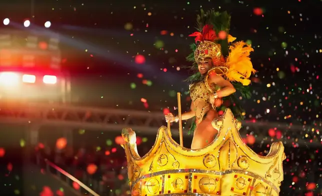 A performer from the Grande Rio samba school parades on a float during Carnival celebrations at the Sambadrome in Rio de Janeiro, Wednesday, Feb. 18, 2026. (AP Photo/Silvia Izquierdo)