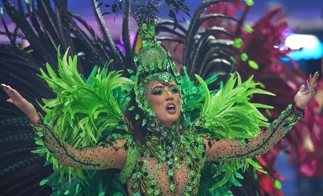 A dancer from the Colorado do Bras samba school performs during a carnival parade in Sao Paulo, Saturday, Feb. 14, 2026. (AP Photo/Andre Penner)