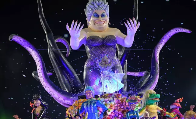 Dancers from the Colorado do Bras samba school perform on a float during a carnival parade in Sao Paulo, Saturday, Feb. 14, 2026. (AP Photo/Andre Penner)