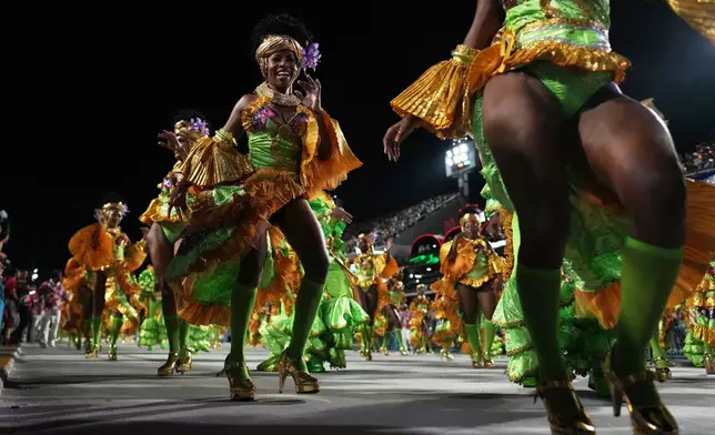 Performers from the Mocidade samba school parade during Carnival celebrations at the Sambadrome in Rio de Janeiro, Monday, Feb. 16, 2026. (AP Photo/Silvia Izquierdo)