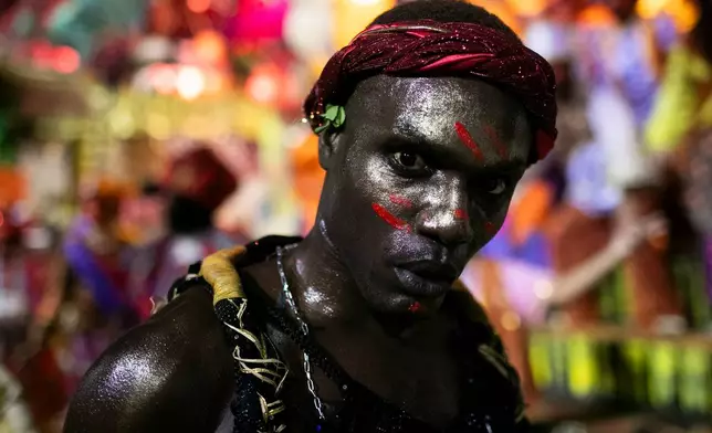 A performer from the Portela samba school parades during Carnival celebrations at the Sambadrome in Rio de Janeiro, early Monday, Feb. 16, 2026. (AP Photo/Bruna Prado)