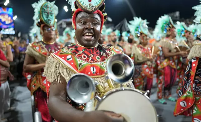 Drummers from the Mocidade Unida da Mooca samba school perform during a carnival parade in Sao Paulo, Friday, Feb. 13, 2026. (AP Photo/Andre Penner)