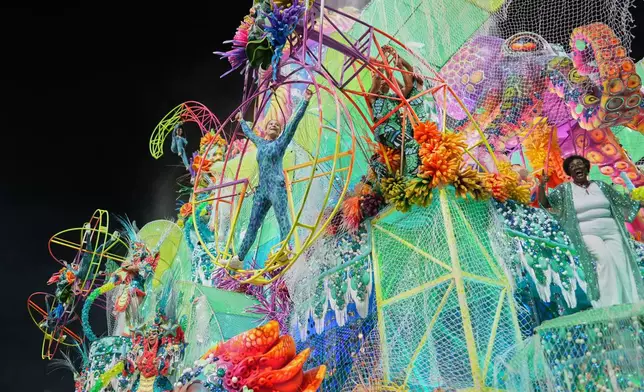 Dancers from the Mocidade Unida da Mooca samba school perform on a float during a carnival parade in Sao Paulo, Friday, Feb. 13, 2026. (AP Photo/Andre Penner)