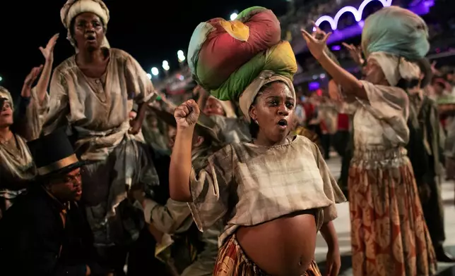 Performers from the Unidos da Tijuca samba school parade during Carnival celebrations at the Sambadrome in Rio de Janeiro, early Tuesday, Feb. 17, 2026. (AP Photo/Bruna Prado)