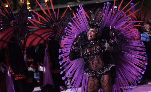 A performer from the Mocidade samba school parades during Carnival celebrations at the Sambadrome in Rio de Janeiro, Monday, Feb. 16, 2026. (AP Photo/Silvia Izquierdo)