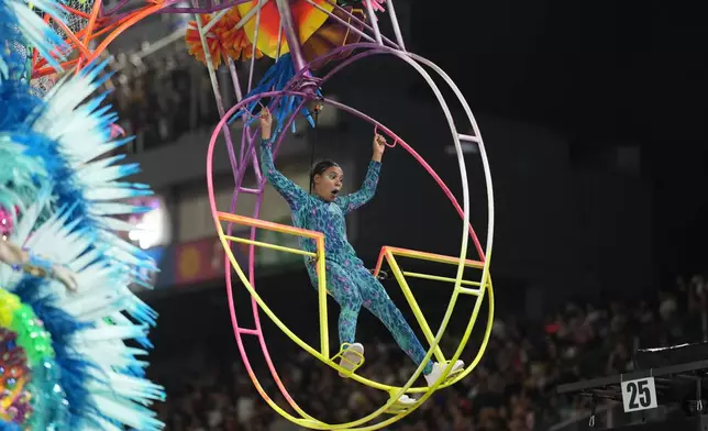 A dancer from the Mocidade Unida da Mooca samba school performs on a float during a carnival parade in Sao Paulo, Friday, Feb. 13, 2026. (AP Photo/Andre Penner)