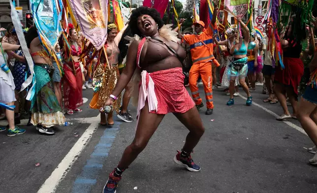 A reveler dances during the "Cordao do Boitata" street pre-carnival party in Rio de Janeiro, Sunday, Feb. 8, 2026. (AP Photo/Bruna Prado)