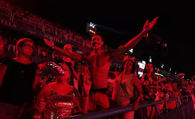 A fan of the Viradouro samba school cheers during Carnival celebrations at the Sambadrome, in Rio de Janeiro, Tuesday, Feb. 17, 2026. (AP Photo/Silvia Izquierdo)