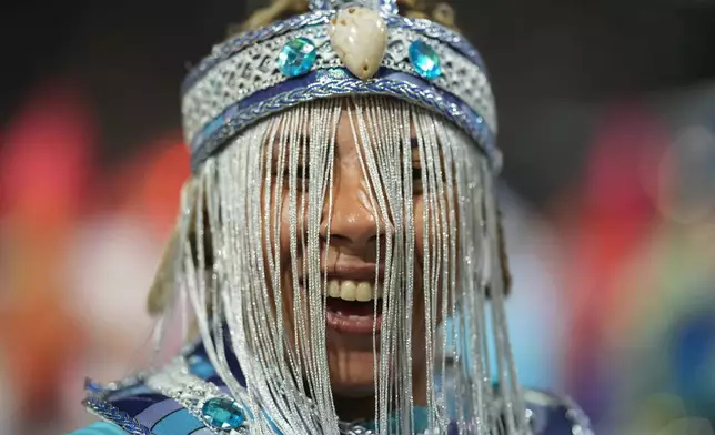 A dancer from the Mocidade Unida da Mooca samba school performs during a carnival parade in Sao Paulo, Friday, Feb. 13, 2026. (AP Photo/Andre Penner)