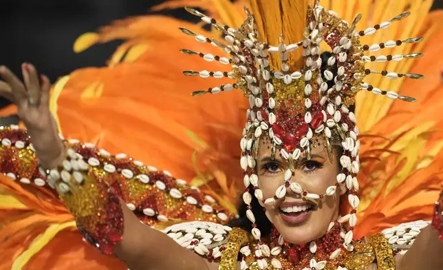 A performer from the Grande Rio samba school parades during Carnival celebrations at the Sambadrome, in Rio de Janeiro, Wednesday, Feb. 18, 2026. (AP Photo/Silvia Izquierdo)