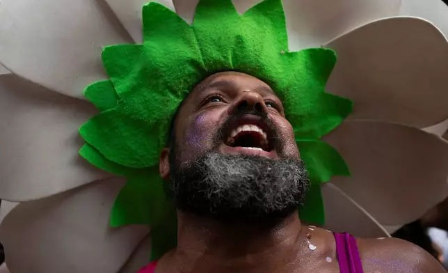 A reveler smiles during the "Ceu na Terra" or "Heaven on Earth" pre-Carnival street party, in Rio de Janeiro, Saturday, Feb. 7, 2026. (AP Photo/Bruna Prado)