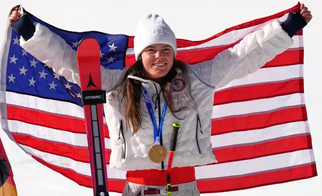 United States' Breezy Johnson celebrates winning the gold medal in the alpine ski women's downhill race, at the 2026 Winter Olympics, in Cortina d'Ampezzo, Italy, Sunday, Feb. 8, 2026. (AP Photo/Robert F. Bukaty)