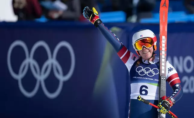 Breezy Johnson of the United States reacts in the finish area of the alpine ski women's downhill race, at the 2026 Winter Olympics, in Cortina d'Ampezzo, Italy, Sunday, Feb. 8, 2026. (Jean-Christophe Bott, Keystone via AP)