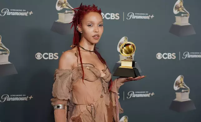 FKA Twigs poses in the press room with the award for best dance/electronic album for "EUSEXUA" during the 68th annual Grammy Awards on Sunday, Feb. 1, 2026, in Los Angeles. (Photo by Richard Shotwell/Invision/AP)