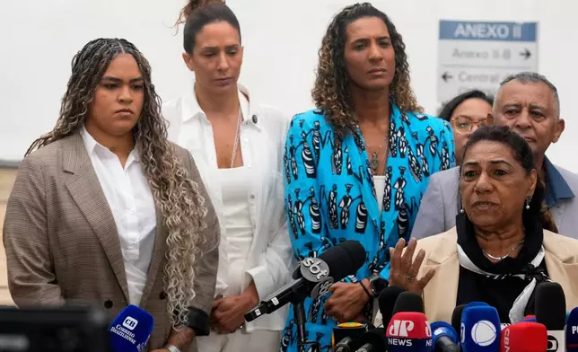 Marinete Silva, mother of councilwoman Marielle Franco, right, gives a news conference with her family at the Supreme Court on the first day of the trial of those accused of ordering her daughter's murder, in Brasilia, Brazil, Tuesday, Feb. 24, 2026. (AP Photo/Eraldo Peres)