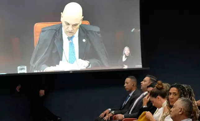 A live image of Judge Alexandre de Moraes is shown at the Supreme Court as family members of the murdered councilwoman Marielle Franco attend the second day of the trial of those accused of ordering the murder of councilwoman Marielle Franco in Brasilia, Brazil, Wednesday, Feb. 25, 2026. (AP Photo/Eraldo Peres)