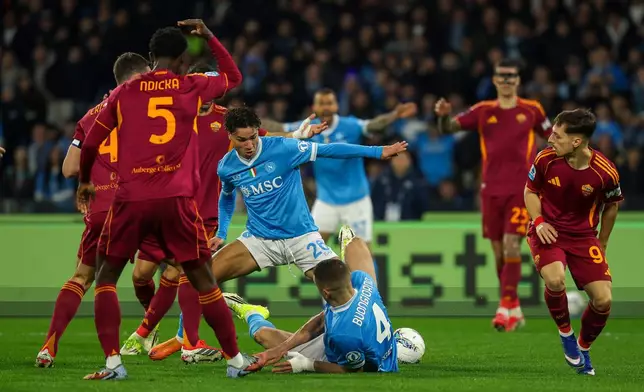 Napoli's Antonio Vergara, centre, challenges during the Serie A soccer match between Napoli and Roma in Naples, Italy, Sunday, Feb. 15, 2026. (Alessandro Garofalo/LaPresse via AP)