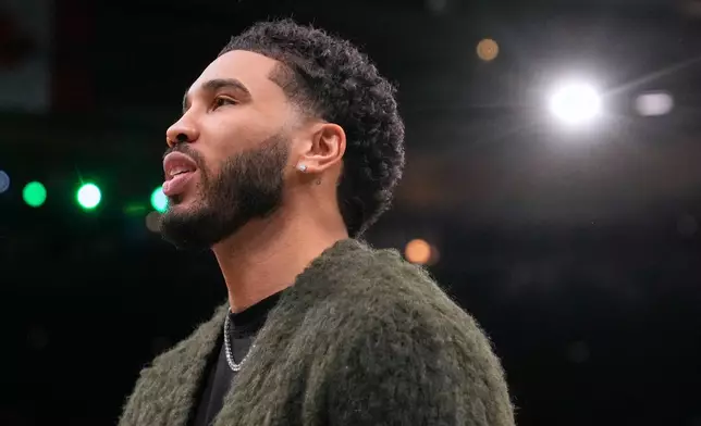Boston Celtics forward Jayson Tatum stands next to the bench during a time out in the first half of an NBA basketball game against the Chicago Bulls, Wednesday, Feb. 11, 2026, in Boston. (AP Photo/Charles Krupa)