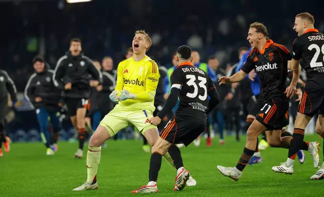 Como's goalkeeper Jean Butez (1) celebrates with teammates after the Italian Cup quarterfinal soccer match against Napoli, Tuesday, Feb. 10, 2026, in Naples, Italy. (Alessandro Garofalo/LaPresse via AP)