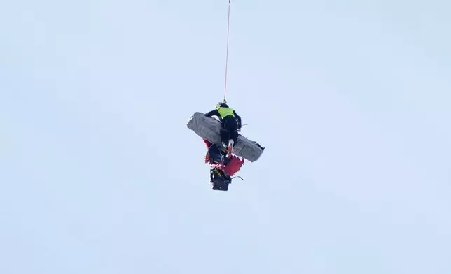 Chile's Henrik von Appen is airlifted after crashing during an alpine ski, men's World Cup downhill, in Crans Montana, Switzerland, Sunday, Feb. 1, 2026. (AP Photo/Giovanni Auletta)