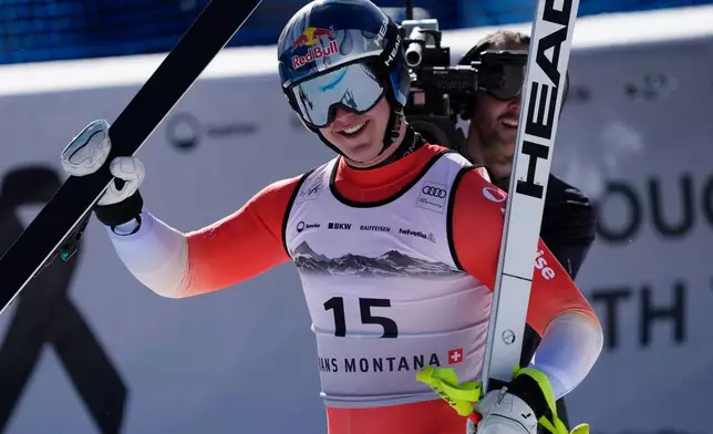 Switzerland's Franjo von Allmen celebrates at the finish area of an alpine ski, men's World Cup downhill, in Crans Montana, Switzerland, Sunday, Feb. 1, 2026. (AP Photo/Giovanni Auletta)