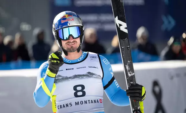 Italy's Dominik Paris celebrates at the finish area of an alpine ski, men's World Cup downhill, in Crans Montana, Switzerland, Sunday, Feb. 1, 2026. (Alessandro della Valle/Keystone via AP)