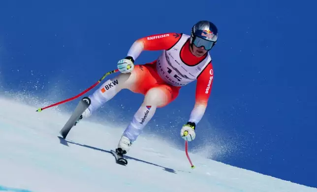 Switzerland's Franjo von Allmen speeds down the course during an alpine ski, men's World Cup downhill, in Crans Montana, Switzerland, Sunday, Feb. 1, 2026. (AP Photo/Pier Marco Tacca)