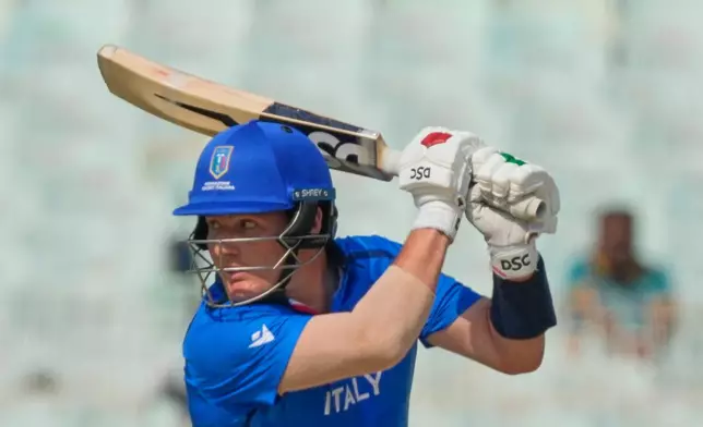 Italy's Harry Manenti plays a shot during the T20 World Cup cricket match between Italy and Scotland in Kolkata, India, Monday, Feb. 9, 2026. (AP Photo/Bikas Das)
